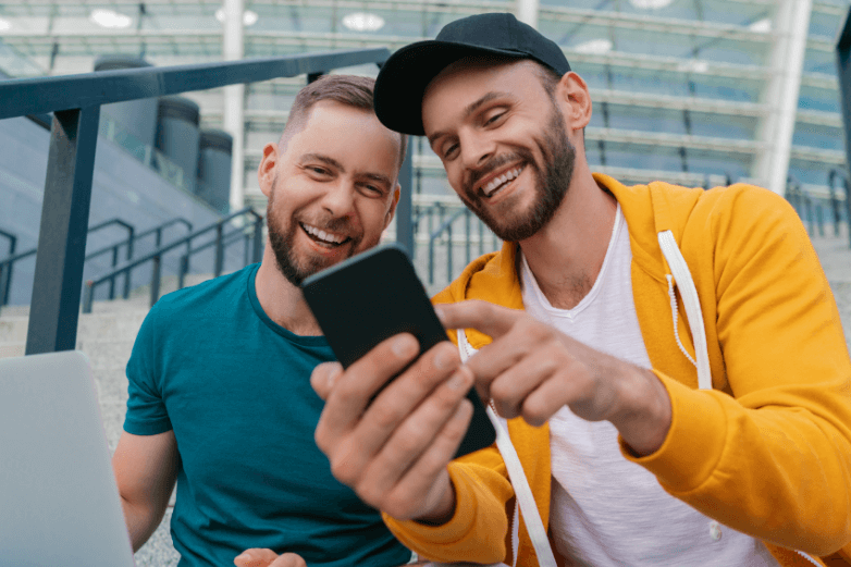 guy showing his friend a social post on his phone