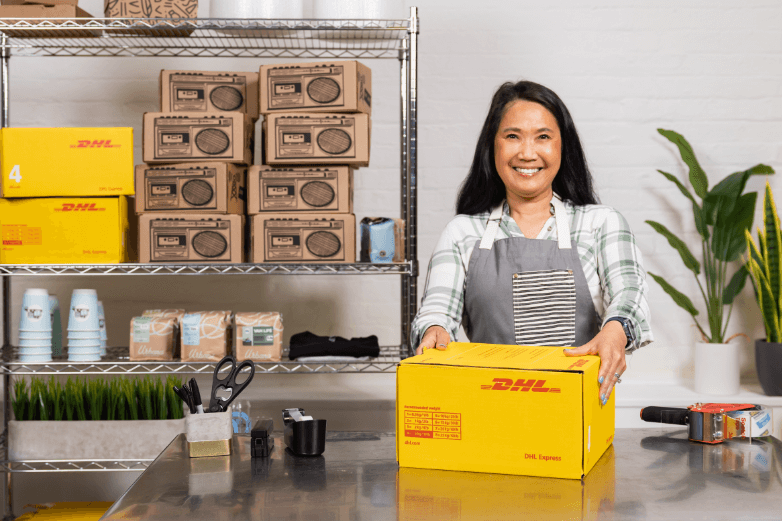 woman packing up DHL boxes