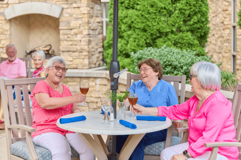 Marquette residents sitting outside drinking wine