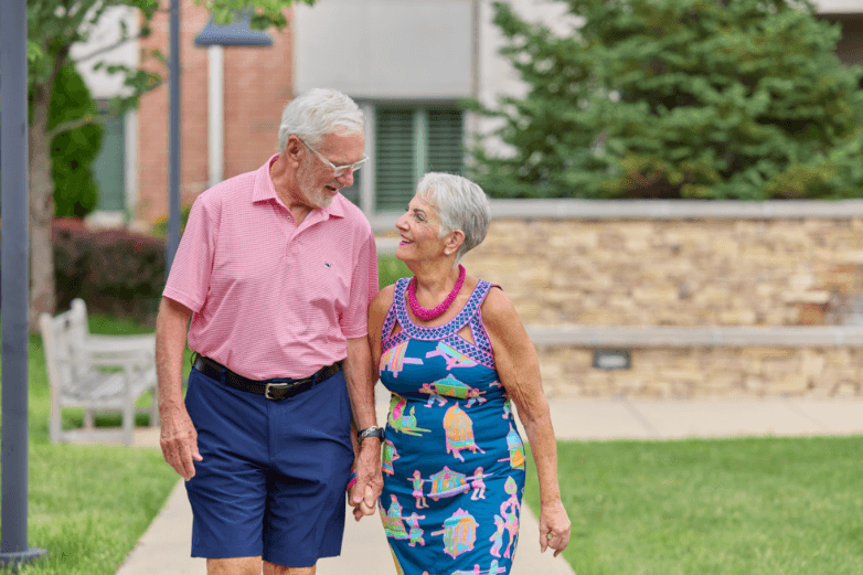 Senior couple walking through Marquette walking paths