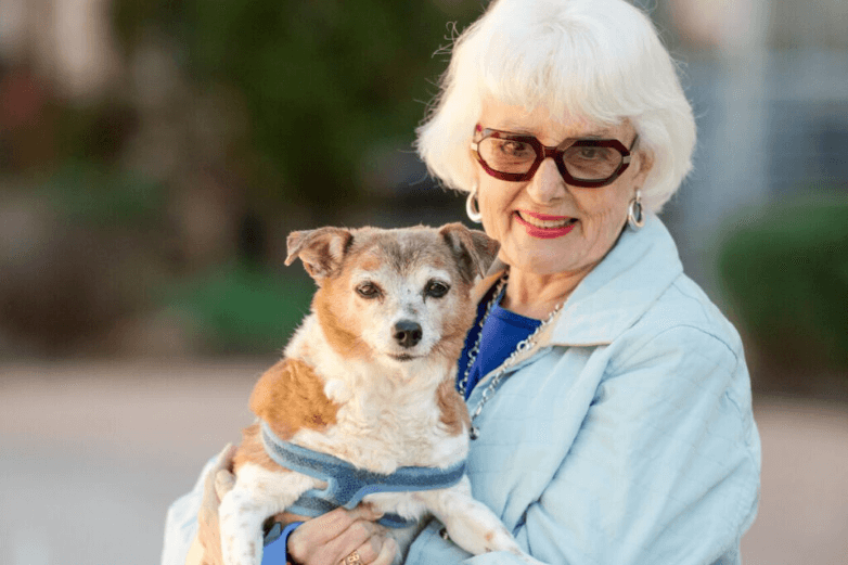 Senior woman holding her dog