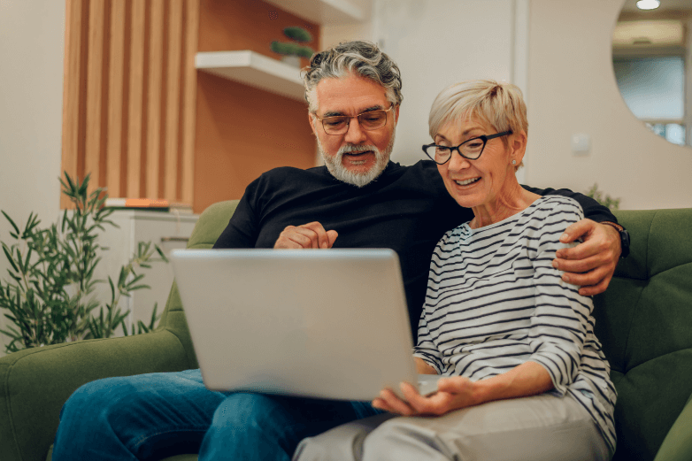 senior couple viewing a website on their laptop